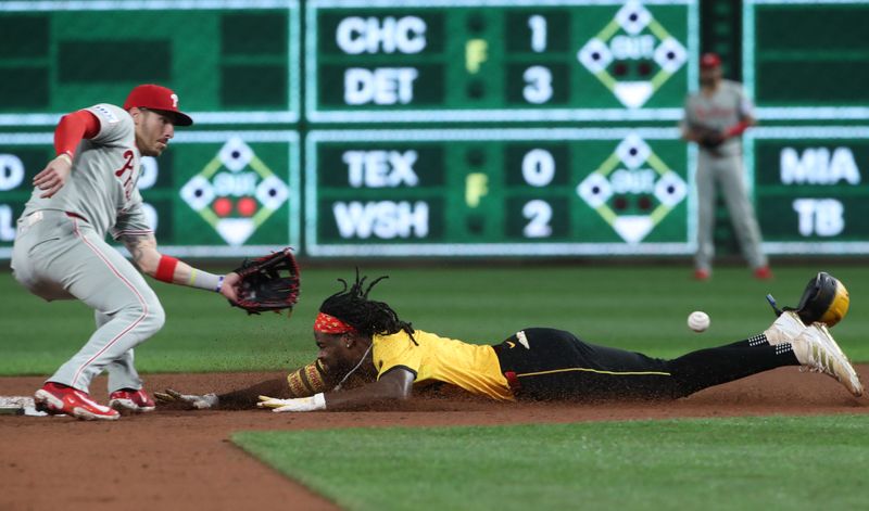 Jun 6, 2025; Pittsburgh, Pennsylvania, USA;  Pittsburgh Pirates center fielder Oneil Cruz (right) beats the throw to Philadelphia Phillies second baseman Bryson Stott (left) on a steal attempt but was ruled out on batter interference  during the fifth inning at PNC Park. Mandatory Credit: Charles LeClaire-Imagn Images
