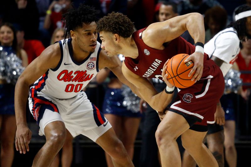 Feb 11, 2023; Oxford, Mississippi, USA; South Carolina Gamecocks forward Benjamin Bosmans-Verdonk (31) handles the ball as Mississippi Rebels forward Jayveous McKinnis (0) defends during the second half at The Sandy and John Black Pavilion at Ole Miss. Mandatory Credit: Petre Thomas-USA TODAY Sports