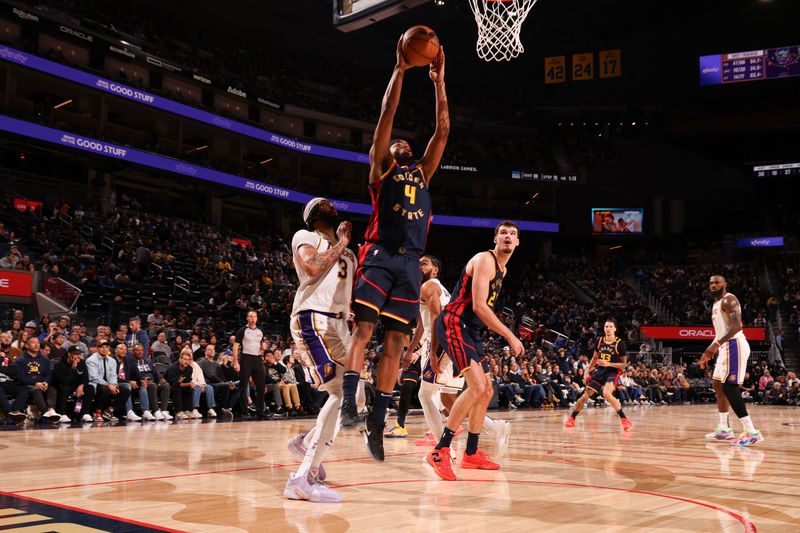 SAN FRANCISCO, CA - JANUARY 25: Moses Moody #4 of the Golden State Warriors drives to the basket during the game against the Los Angeles Lakers  on January 25, 2025 at Chase Center in San Francisco, California. NOTE TO USER: User expressly acknowledges and agrees that, by downloading and or using this photograph, user is consenting to the terms and conditions of Getty Images License Agreement. Mandatory Copyright Notice: Copyright 2025 NBAE (Photo by Jed Jacobsohn/NBAE via Getty Images)