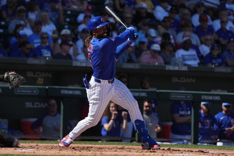 Feb 24, 2026; Mesa, Arizona, USA; Chicago Cubs center fielder Justin Dean (1) hits a single against the San Diego Padres in the second inning at Sloan Park. Mandatory Credit: Rick Scuteri-Imagn Images