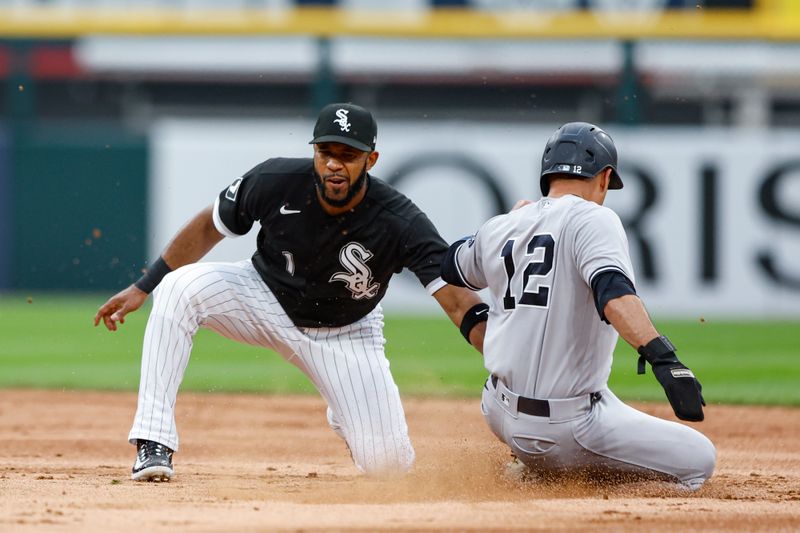 Aug 9, 2023; Chicago, Illinois, USA; New York Yankees center fielder Isiah Kiner-Falefa (12) is caught stealing second base by Chicago White Sox shortstop Elvis Andrus (1) during the second inning at Guaranteed Rate Field. Mandatory Credit: Kamil Krzaczynski-USA TODAY Sports