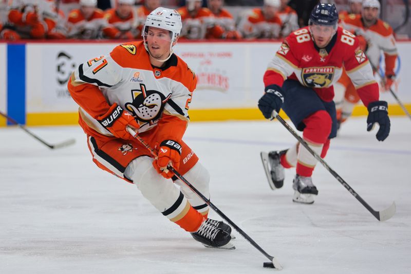 Jan 18, 2025; Sunrise, Florida, USA; Anaheim Ducks center Isac Lundestrom (21) moves the puck against the Florida Panthers during the first period at Amerant Bank Arena. Mandatory Credit: Sam Navarro-Imagn Images