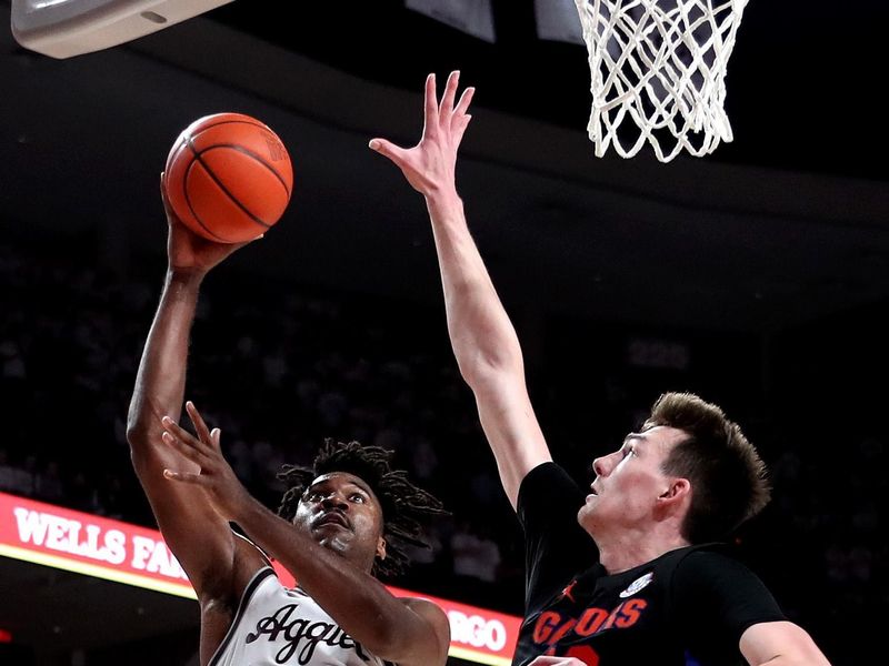 Jan 18, 2023; College Station, Texas, USA;Texas A&M Aggies forward Julius Marble (34) shoots the ball while Florida Gators forward Colin Castleton (12) defends during the second half at Reed Arena. Mandatory Credit: Erik Williams-USA TODAY Sports
