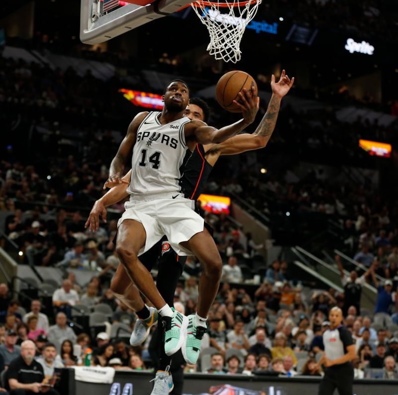 SAN ANTONIO, TX - APRIL 14:  Blake Wesley #14 of the San Antonio Spurs goes up for a shot against Jared Rhoden #8 of the Detroit Pistons in the second half at Frost Bank Center on April 14, 2024 in San Antonio, Texas. NOTE TO USER: User expressly acknowledges and agrees that, by downloading and or using this photograph, User is consenting to terms and conditions of the Getty Images License Agreement. (Photo by Ronald Cortes/Getty Images)