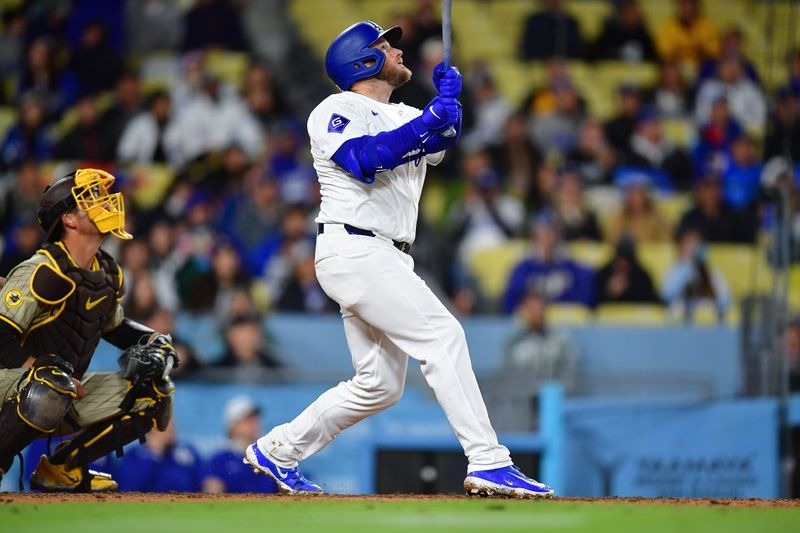 Apr 13, 2024; Los Angeles, California, USA; Los Angeles Dodgers third baseman Max Muncy (13) hits a sacrifice RBI against the San Diego Padres during the seventh inning at Dodger Stadium. Mandatory Credit: Gary A. Vasquez-USA TODAY Sports