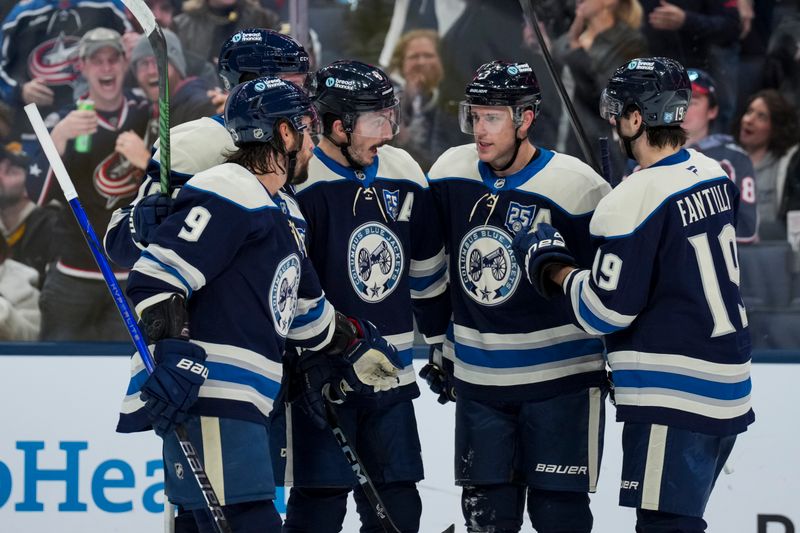 Nov 28, 2025; Columbus, Ohio, USA;  Columbus Blue Jackets defenseman Zach Werenski (8) celebrates with teammates after scoring a goal against the Pittsburgh Penguins in the second period at Nationwide Arena. Mandatory Credit: Aaron Doster-Imagn Images