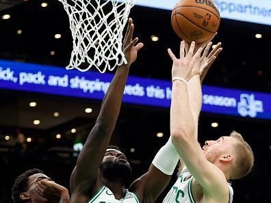 Boston, MA - December 28: Boston Celtics Neemias Queta and Sam Hauser go up for a rebound in the first quarter. The Celtics beat the Detroit Pistons, 128-122, in overtime. (Photo by Danielle Parhizkaran/The Boston Globe via Getty Images)