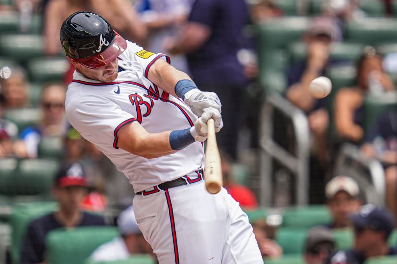 Jun 19, 2024; Cumberland, Georgia, USA; Atlanta Braves catcher Sean Murphy (12) hits a two run home run against the Detroit Tigers during the third inning at Truist Park. Mandatory Credit: Dale Zanine-USA TODAY Sports