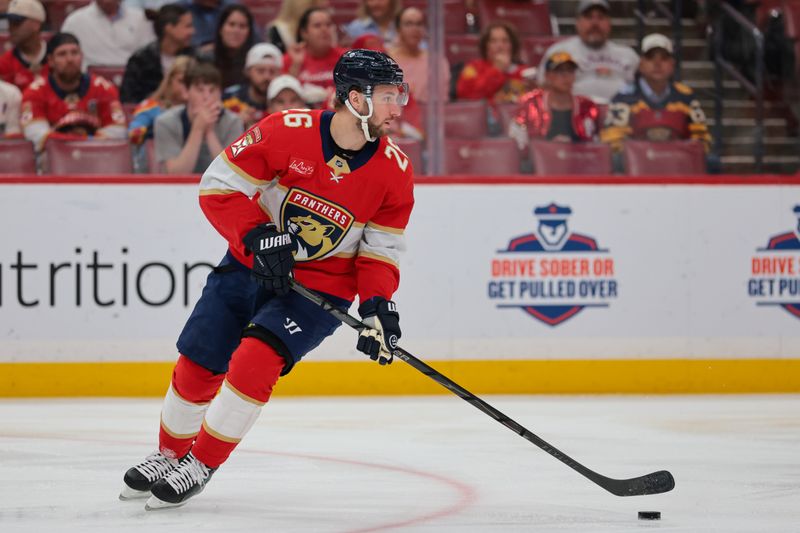 Feb 27, 2026; Sunrise, Florida, USA; Florida Panthers defenseman Uvis Balinskis (26) moves the puck against the Buffalo Sabres during the first period at Amerant Bank Arena. Mandatory Credit: Sam Navarro-Imagn Images