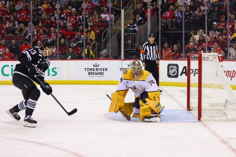 Nov 25, 2024; Newark, New Jersey, USA; New Jersey Devils center Nico Hischier (13) scores a goal on Nashville Predators goaltender Juuse Saros (74) during the second period at Prudential Center. Mandatory Credit: Ed Mulholland-Imagn Images