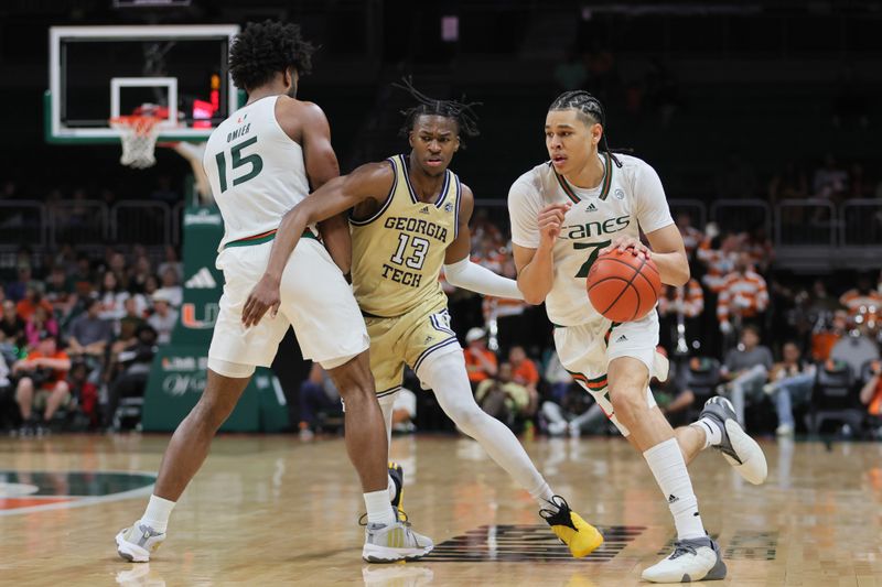 Feb 24, 2024; Coral Gables, Florida, USA; Miami Hurricanes guard Kyshawn George (7) drives to the basket past Georgia Tech Yellow Jackets guard Miles Kelly (13) during the second half at Watsco Center. Mandatory Credit: Sam Navarro-USA TODAY Sports