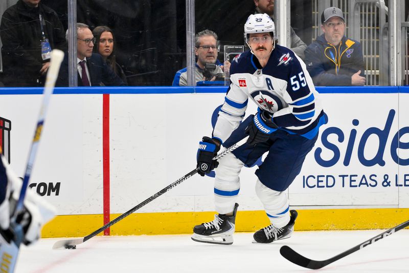 Dec 17, 2025; St. Louis, Missouri, USA; Winnipeg Jets center Mark Scheifele (55) controls the puck against the St. Louis Blues during the first period at Enterprise Center. Mandatory Credit: Jeff Curry-Imagn Images