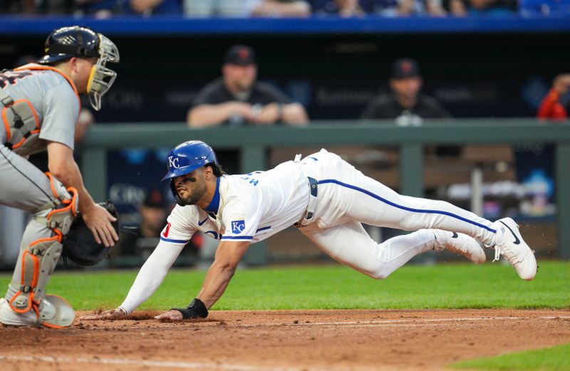 May 20, 2024; Kansas City, Missouri, USA; Kansas City Royals left fielder MJ Melendez (1) slides into home to score a run against Detroit Tigers catcher Jake Rogers (34) during the sixth inning at Kauffman Stadium. Mandatory Credit: Jay Biggerstaff-USA TODAY Sports