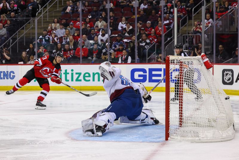 Feb 6, 2024; Newark, New Jersey, USA; New Jersey Devils left wing Jesper Bratt (63) scores a goal on Colorado Avalanche goaltender Justus Annunen (60) during the second period at Prudential Center. Mandatory Credit: Ed Mulholland-USA TODAY Sports