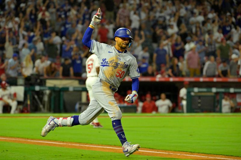 Sep 3, 2024; Anaheim, California, USA;  Los Angeles Dodgers shortstop Mookie Betts (50) celebrates as he rounds the bases after hitting a three-run home run in the tenth inning against the Los Angeles Angels at Angel Stadium. Mandatory Credit: Jayne Kamin-Oncea-Imagn Images