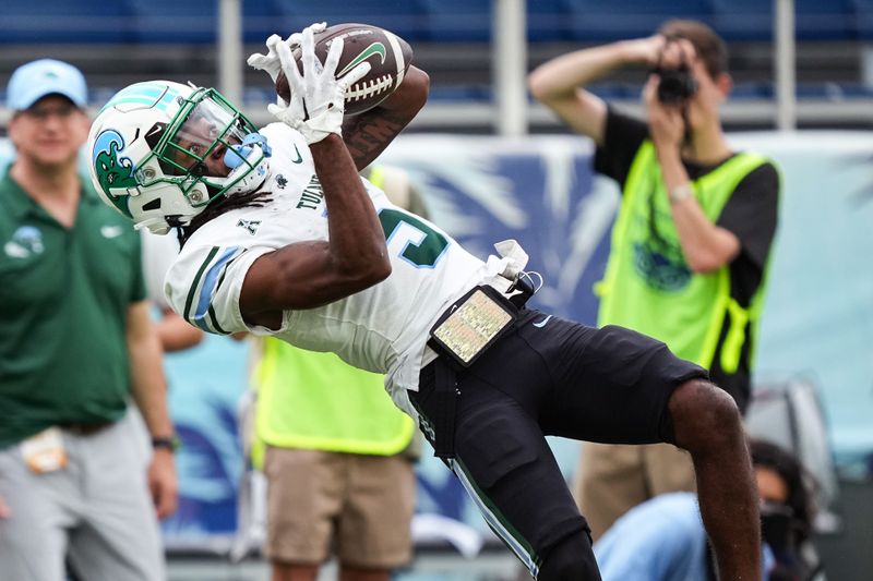 Nov 18, 2023; Boca Raton, Florida, USA; Tulane Green Wave wide receiver Yulkeith Brown (5) catches a pass over Florida Atlantic Owls cornerback Romain Mungin (2) in the second half at FAU Stadium. Mandatory Credit: Jim Rassol-USA TODAY Sports