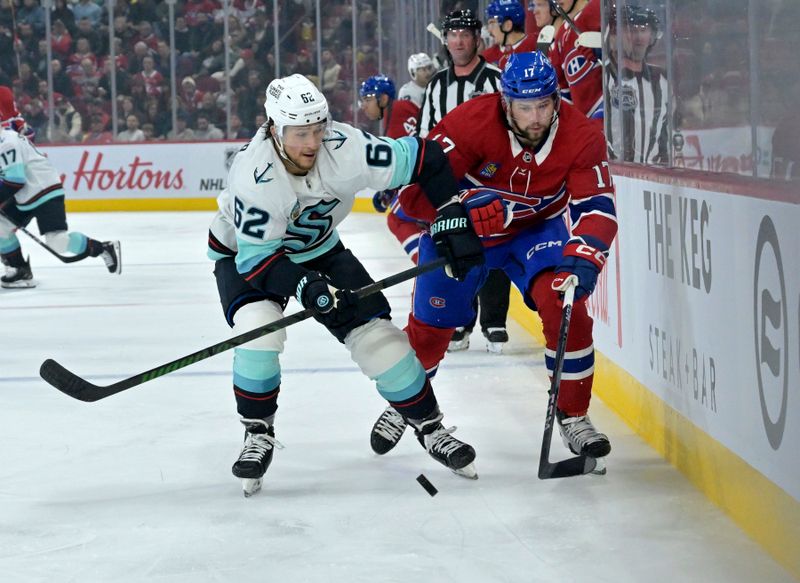 Oct 29, 2024; Montreal, Quebec, CAN; Seattle Kraken defenseman Brandon Montour (62) takes the puck away from Montreal Canadiens forward Josh Anderson (17) during the second period at the Bell Centre. Mandatory Credit: Eric Bolte-Imagn Images