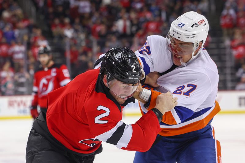 Nov 28, 2023; Newark, New Jersey, USA; New York Islanders left wing Anders Lee (27) and New Jersey Devils defenseman Brendan Smith (2) fight during the third period at Prudential Center. Mandatory Credit: Ed Mulholland-USA TODAY Sports