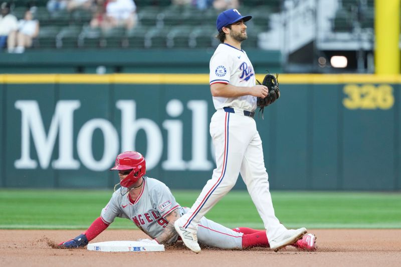 Sep 7, 2024; Arlington, Texas, USA; Los Angeles Angels shortstop Zach Neto (9) steals second base past Texas Rangers short stop Josh Smith (8) during the first inning at Globe Life Field. Mandatory Credit: Jim Cowsert-Imagn Images