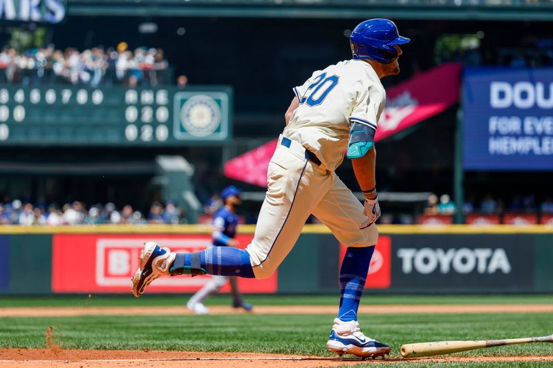 Jun 16, 2024; Seattle, Washington, USA; Seattle Mariners left fielder Luke Raley (20) hits an RBI-double against the Texas Rangers during the fourth inning at T-Mobile Park. Mandatory Credit: Joe Nicholson-USA TODAY Sports