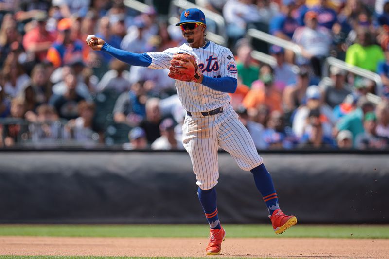 Aug 21, 2024; New York City, New York, USA; New York Mets shortstop Francisco Lindor (12) throws the ball to first base for an out during the sixth inning against the Baltimore Orioles at Citi Field. Mandatory Credit: Vincent Carchietta-USA TODAY Sports