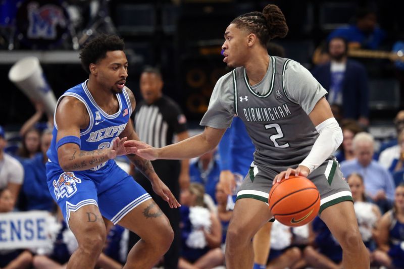 Mar 3, 2024; Memphis, Tennessee, USA; UAB Blazers guard Daniel Ortiz (2) dribbles as Memphis Tigers guard Joe Cooper (20) defends during the first half at FedExForum. Mandatory Credit: Petre Thomas-USA TODAY Sports