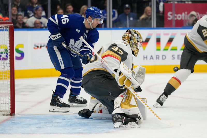 Nov 20, 2024; Toronto, Ontario, CAN; Toronto Maple Leafs forward Alex Steeves (46) and Vegas Golden Knights goaltender Adin Hill (33) follow a puck during the third period at Scotiabank Arena. Mandatory Credit: John E. Sokolowski-Imagn Images