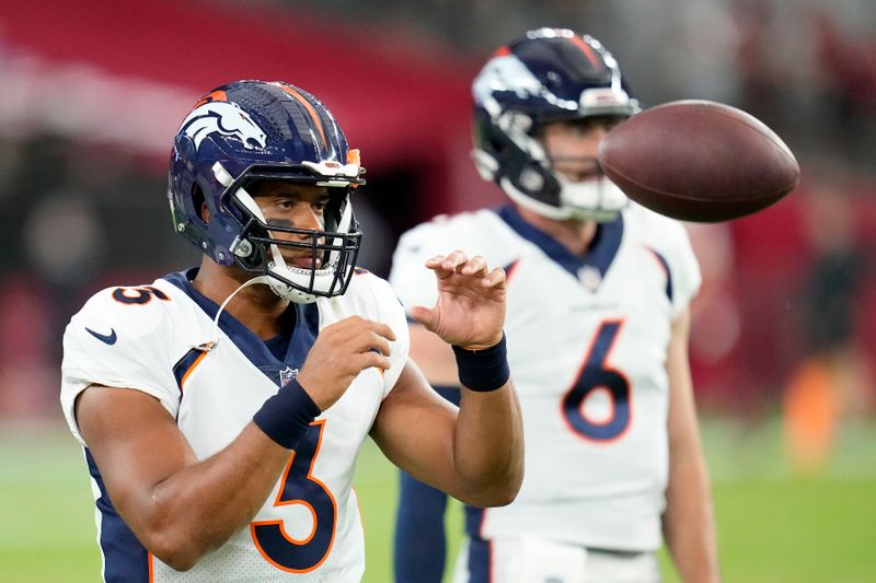 Denver Broncos quarterback Russell Wilson warms up prior to an NFL preseason football game against the Arizona Cardinals, Friday, Aug. 11, 2023, in Glendale, Ariz. The Cardinals won 18-17. (AP Photo/Ross D. Franklin)