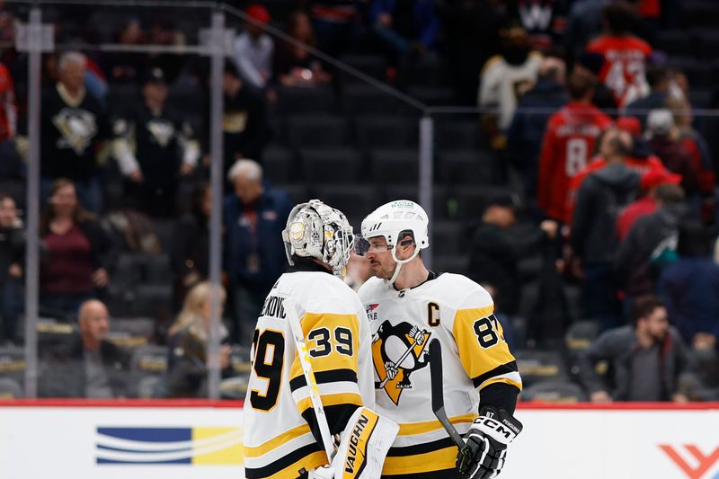 Apr 4, 2024; Washington, District of Columbia, USA; Pittsburgh Penguins center Sidney Crosby (87) celebrates with Penguins goaltender Alex Nedeljkovic (39) after their game against the Washington Capitals at Capital One Arena. Mandatory Credit: Geoff Burke-USA TODAY Sports