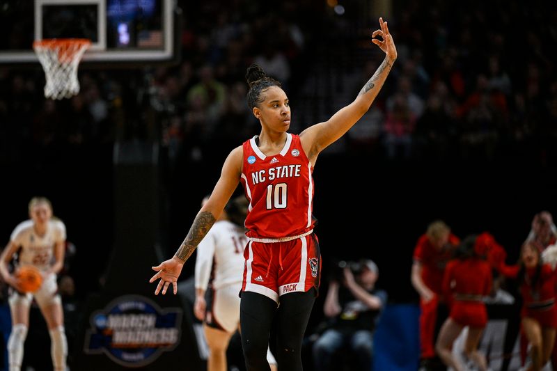 Mar 29, 2024; Portland, OR, USA; NC State Wolfpack guard Aziaha James (10) celebrates after scoring a three point basket in the second half against the Stanford Cardinal in the semifinals of the Portland Regional of the 2024 NCAA Tournament at the Moda Center at the Moda Center. Mandatory Credit: Troy Wayrynen-USA TODAY Sports