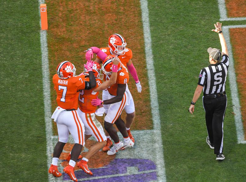 Oct 7, 2023; Clemson, South Carolina, USA; Clemson quarterback Cade Klubnik (2) is congratulated by teammates running back Phil Mafah (7) and wide receiver Adam Randall (8) after running in the end zone for a touchdown against Wake Forest during the second quarter at Memorial Stadium. Mandatory Credit: Ken Ruinard-USA TODAY Sports