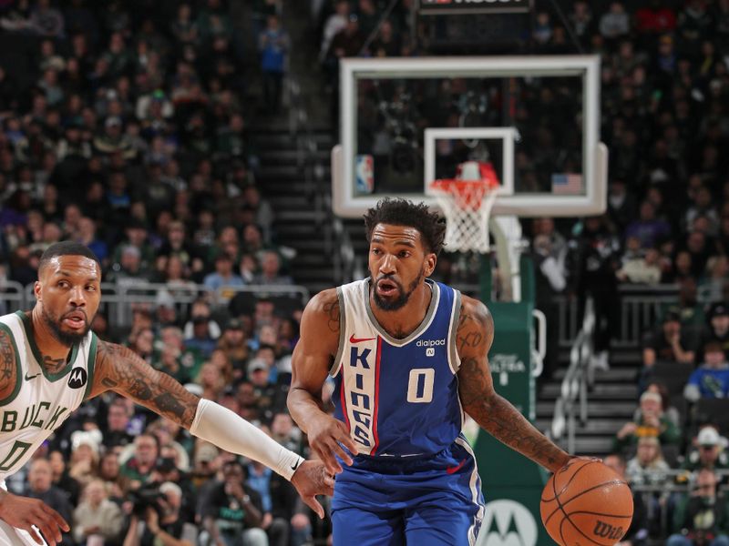 MILWAUKEE, WI - JANUARY 14: Malik Monk #0 of the Sacramento Kings dribbles the ball during the game against the Milwaukee Bucks on January 14, 2024 at the Fiserv Forum Center in Milwaukee, Wisconsin. NOTE TO USER: User expressly acknowledges and agrees that, by downloading and or using this Photograph, user is consenting to the terms and conditions of the Getty Images License Agreement. Mandatory Copyright Notice: Copyright 2024 NBAE (Photo by Gary Dineen/NBAE via Getty Images).