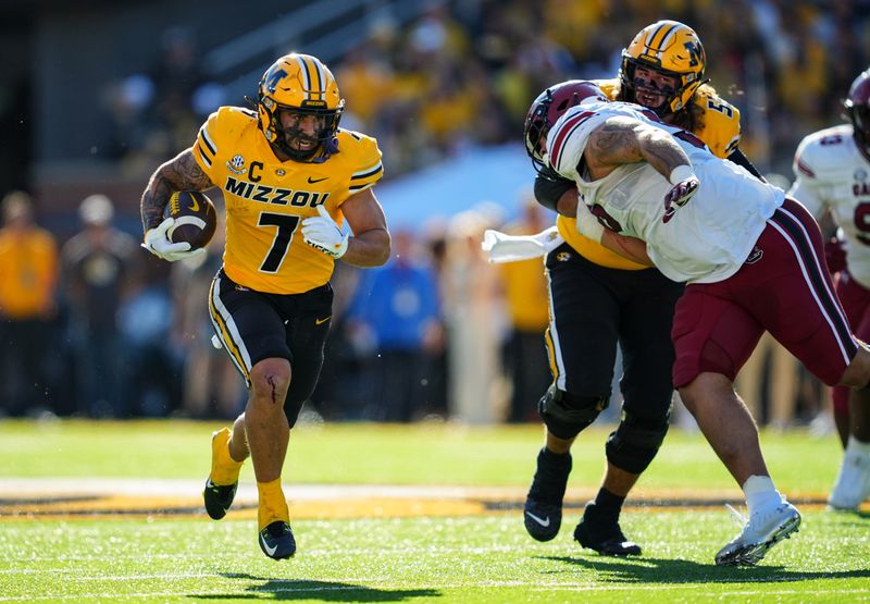 Oct 21, 2023; Columbia, Missouri, USA; Missouri Tigers running back Cody Schrader (7) runs the ball against South Carolina Gamecocks defensive tackle D'Andre Martin (99) during the first half at Faurot Field at Memorial Stadium. Mandatory Credit: Jay Biggerstaff-USA TODAY Sports