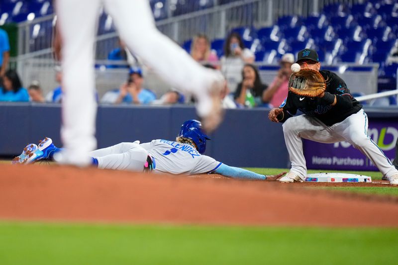 Jun 7, 2023; Miami, Florida, USA; Kansas City Royals right fielder MJ Melendez (1) slides back into first base as Miami Marlins first baseman Yuli Gurriel (10) catches the ball during the fourth inning at loanDepot Park. Mandatory Credit: Rich Storry-USA TODAY Sports