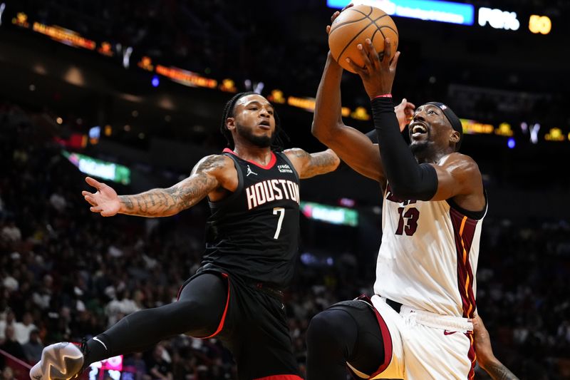 MIAMI, FLORIDA - JANUARY 08: Bam Adebayo #13 of the Miami Heat gors up for a shot over Cam Whitmore #7 of the Houston Rockets during the first half at Kaseya Center on January 08, 2024 in Miami, Florida. NOTE TO USER: User expressly acknowledges and agrees that, by downloading and or using this photograph, User is consenting to the terms and conditions of the Getty Images License Agreement. (Photo by Rich Storry/Getty Images)