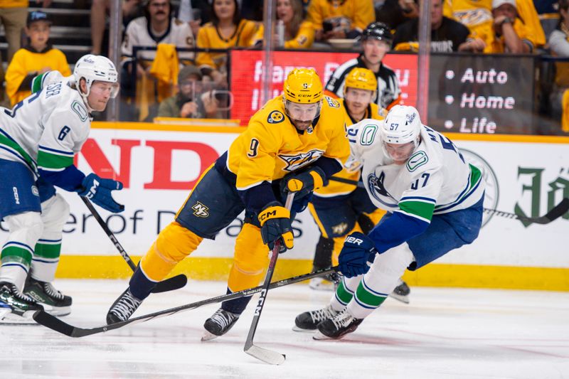 Apr 26, 2024; Nashville, Tennessee, USA; Vancouver Canucks defenseman Tyler Myers (57) fights with Nashville Predators left wing Filip Forsberg (9) for the puck during the third period in game three of the first round of the 2024 Stanley Cup Playoffs at Bridgestone Arena. Mandatory Credit: Steve Roberts-USA TODAY Sports