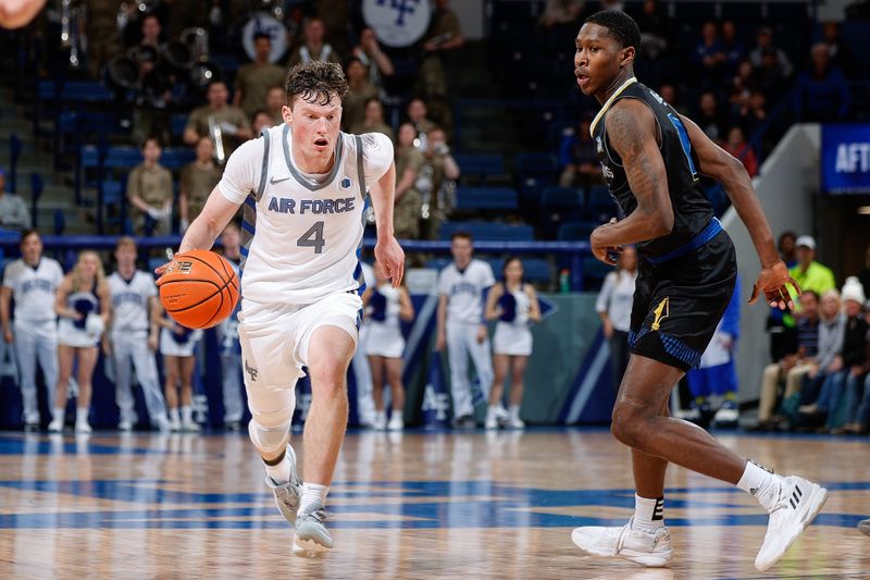 Mar 4, 2023; Colorado Springs, Colorado, USA; Air Force Falcons guard Carter Murphy (4) controls the ball as San Jose State Spartans guard Omari Moore (10) guards in the second half at Clune Arena. Mandatory Credit: Isaiah J. Downing-USA TODAY Sports