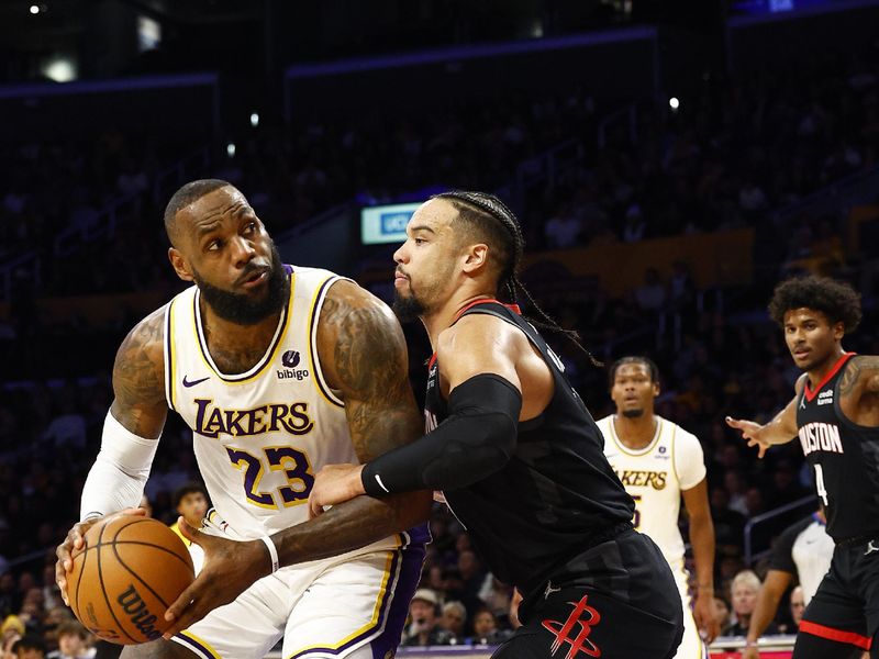 LOS ANGELES, CALIFORNIA - DECEMBER 02: LeBron James #23 of the Los Angeles Lakers controls the ball against Dillon Brooks #9 of the Houston Rockets in the first quarter at Crypto.com Arena on December 02, 2023 in Los Angeles, California.   NOTE TO USER: User expressly acknowledges and agrees that, by downloading and/or using this photograph, user is consenting to the terms and conditions of the Getty Images License Agreement. (Photo by Ronald Martinez/Getty Images)