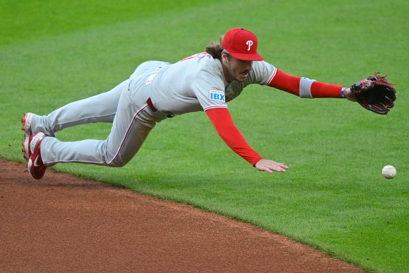May 9, 2025; Cleveland, Ohio, USA; Philadelphia Phillies second baseman Bryson Stott (5) dives for the ball on a base hit in the second inning against the Cleveland Guardians at Progressive Field. Mandatory Credit: David Richard-Imagn Images
