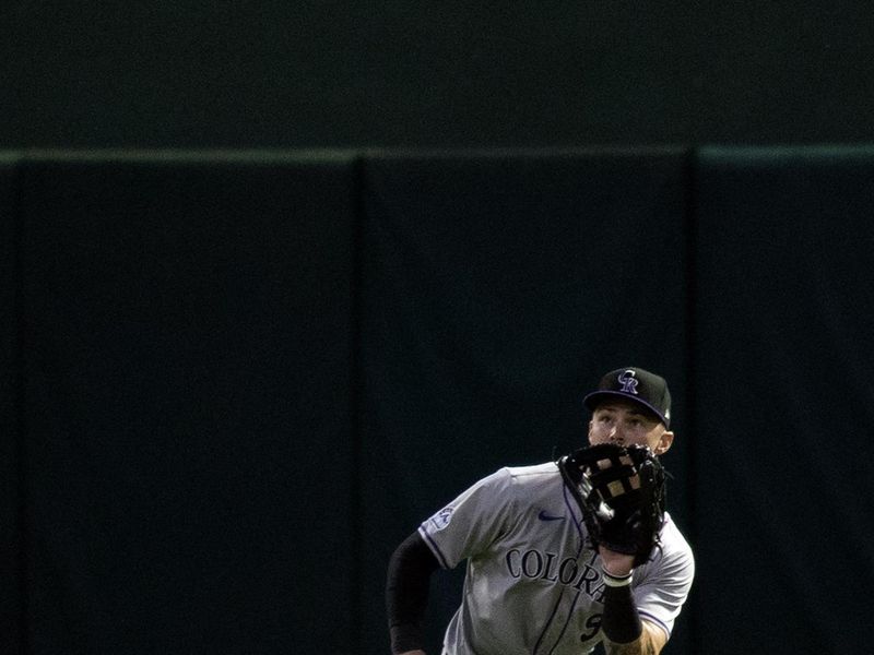 May 22, 2024; Oakland, California, USA; Colorado Rockies center fielder Brenton Doyle (9) makes a catch of a line drive off the bat of Oakland Athletics right fielder Tyler Nevin  (not pictured) during the seventh inning at Oakland-Alameda County Coliseum. Mandatory Credit: D. Ross Cameron-USA TODAY Sports