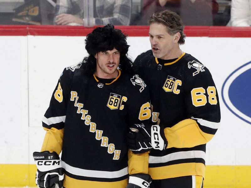 Feb 18, 2024; Pittsburgh, Pennsylvania, USA;  Pittsburgh Penguins center Sidney Crosby (left) talks with former right wing Jaromir Jagr (68) before the game against the Los Angeles Kings at PPG Paints Arena. Mandatory Credit: Charles LeClaire-USA TODAY Sports