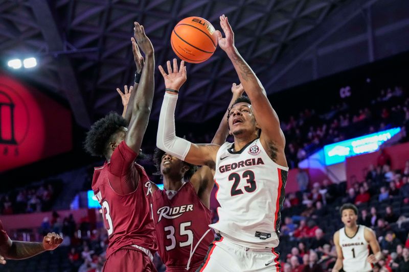 Dec 28, 2022; Athens, Georgia, USA; Georgia Bulldogs center Braelen Bridges (23) is fouled by Rider Broncs forward Ajiri Ogemuno-Johnson (13) during the first half at Stegeman Coliseum. Mandatory Credit: Dale Zanine-USA TODAY Sports