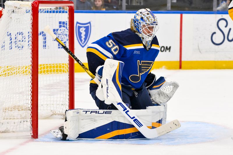 Mar 23, 2025; St. Louis, Missouri, USA;  St. Louis Blues goaltender Jordan Binnington (50) defends the net against the Nashville Predators during the first period at Enterprise Center. Mandatory Credit: Jeff Curry-Imagn Images