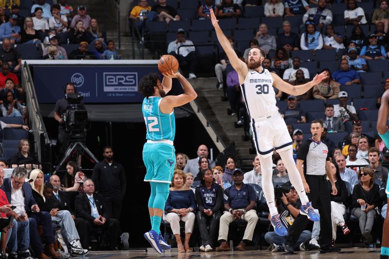 MEMPHIS, TN - OCTOBER 10: Vasilije Micic #22 of the Charlotte Hornets shoots a three point basket defended by Jay Huff #30 of the Memphis Grizzlies during a NBA Preseason game on October 10, 2024 at FedExForum in Memphis, Tennessee. NOTE TO USER: User expressly acknowledges and agrees that, by downloading and or using this photograph, User is consenting to the terms and conditions of the Getty Images License Agreement. Mandatory Copyright Notice: Copyright 2024 NBAE (Photo by Joe Murphy/NBAE via Getty Images)