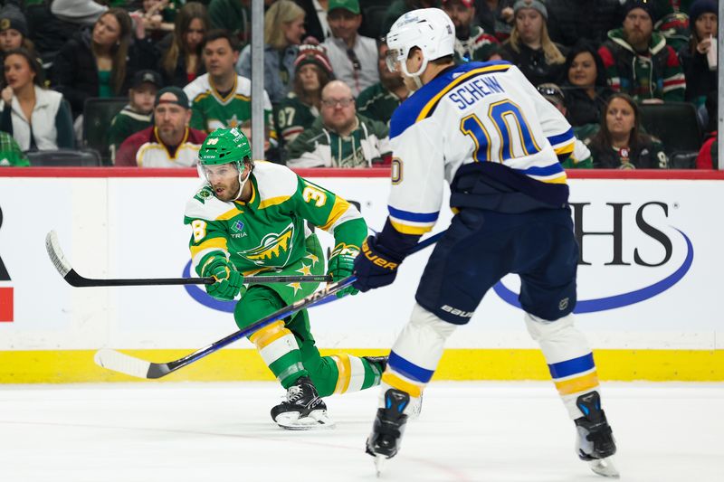 Mar 23, 2024; Saint Paul, Minnesota, USA; Minnesota Wild right wing Ryan Hartman (38) shoots as St. Louis Blues center Brayden Schenn (10) defends during the first period at Xcel Energy Center. Mandatory Credit: Matt Krohn-USA TODAY Sports