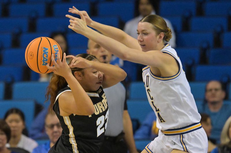 Jan 21, 2026; Los Angeles, California, USA; UCLA Bruins forward Amanda Muse (33) pressures Purdue Boilermakers guard Kiki Smith (23) in the first half at Pauley Pavilion presented by Wescom Financial. Mandatory Credit: Jayne Kamin-Oncea-Imagn Images