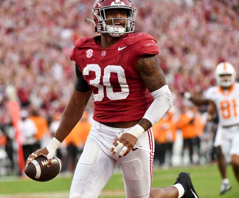 Oct 21, 2023; Tuscaloosa, Alabama, USA; Alabama Crimson Tide linebacker Jihaad Campbell (30) recovers a fumble and runs it in for a touchdown against Tennessee at Bryant-Denny Stadium. Alabama defeated Tennessee 34-20. Mandatory Credit: Gary Cosby Jr.-USA TODAY Sports