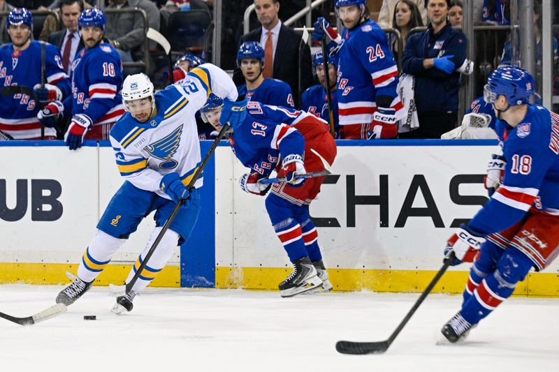 Nov 24, 2025; New York, New York, USA;  St. Louis Blues right wing Jordan Kyrou (25) controls the puck defended by New York Rangers defenseman Urho Vaakanainen (18) during the first period at Madison Square Garden. Mandatory Credit: Dennis Schneidler-Imagn Images