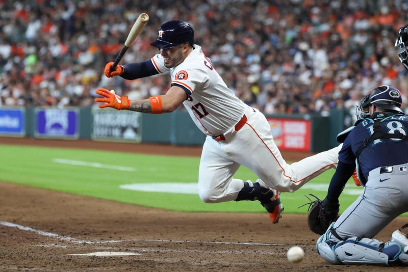 May 24, 2025; Houston, Texas, USA; Houston Astros catcher Victor Caratini (17) reacts after being hit by a pitch during the fifth inning against the Seattle Mariners at Daikin Park. Mandatory Credit: Troy Taormina-Imagn Images