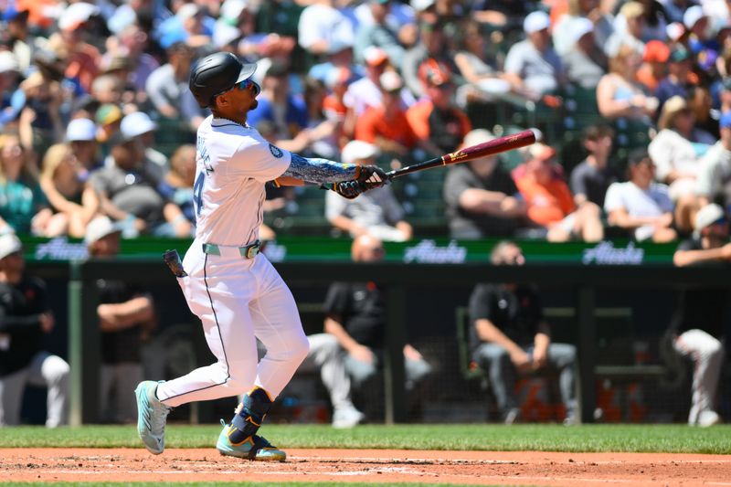 Jul 4, 2024; Seattle, Washington, USA; Seattle Mariners center fielder Julio Rodriguez (44) hits a home run against the Baltimore Orioles during the fifth inning at T-Mobile Park. Mandatory Credit: Steven Bisig-USA TODAY Sports